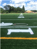 Artificial turf football yard lines and numbers being installed