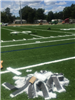 Artificial turf football yard lines and numbers being installed