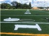 Artificial turf football yard lines and numbers being installed