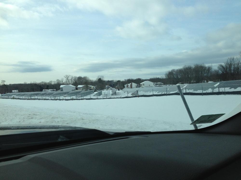 Solar panels in the winter from the view of a truck