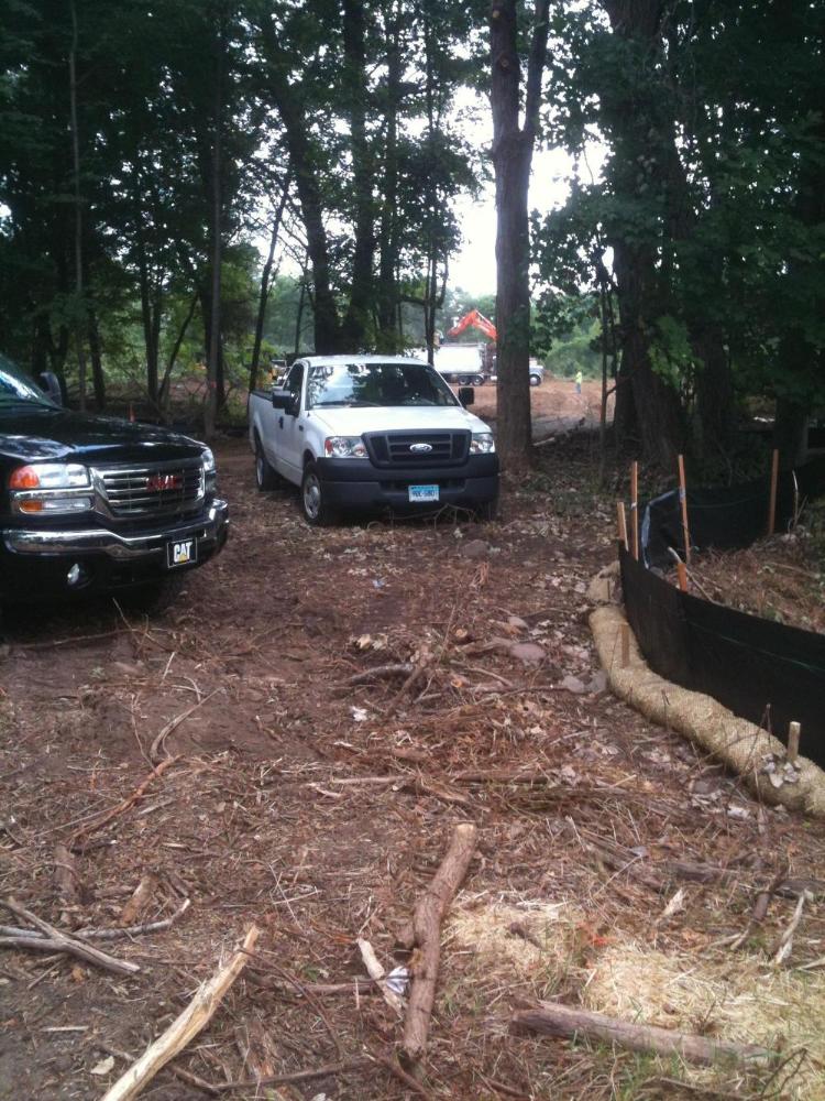 Trucks in front with clearing of land for solar farm in background