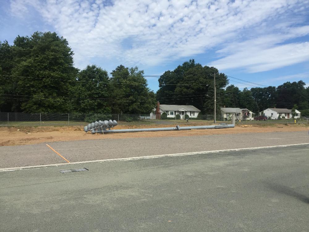 Stadium light pole laying on ground