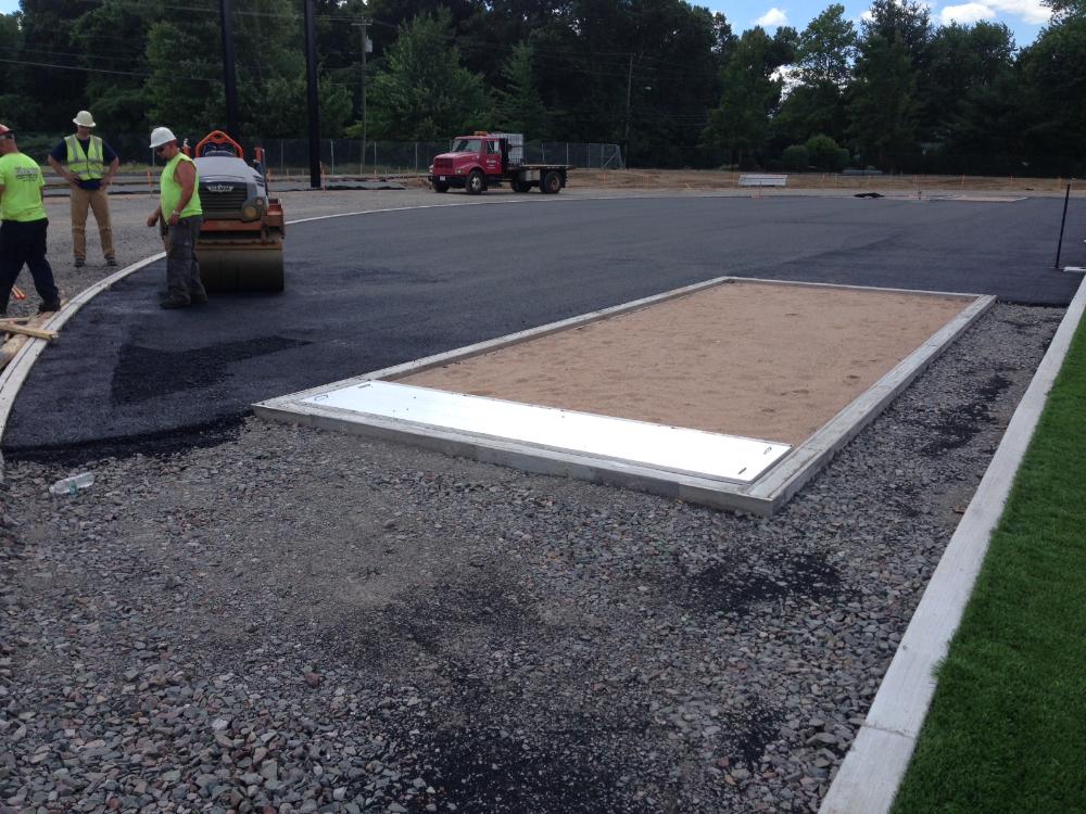 Workers laying the infield track material