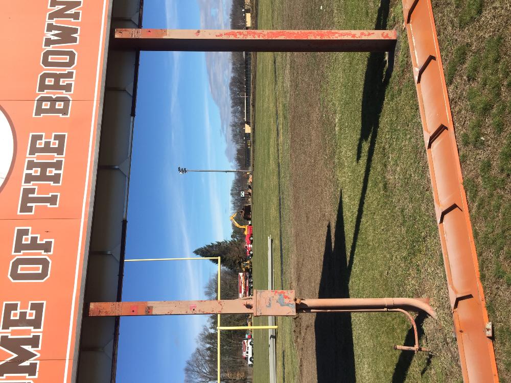 Workers on large machines working on the track infield